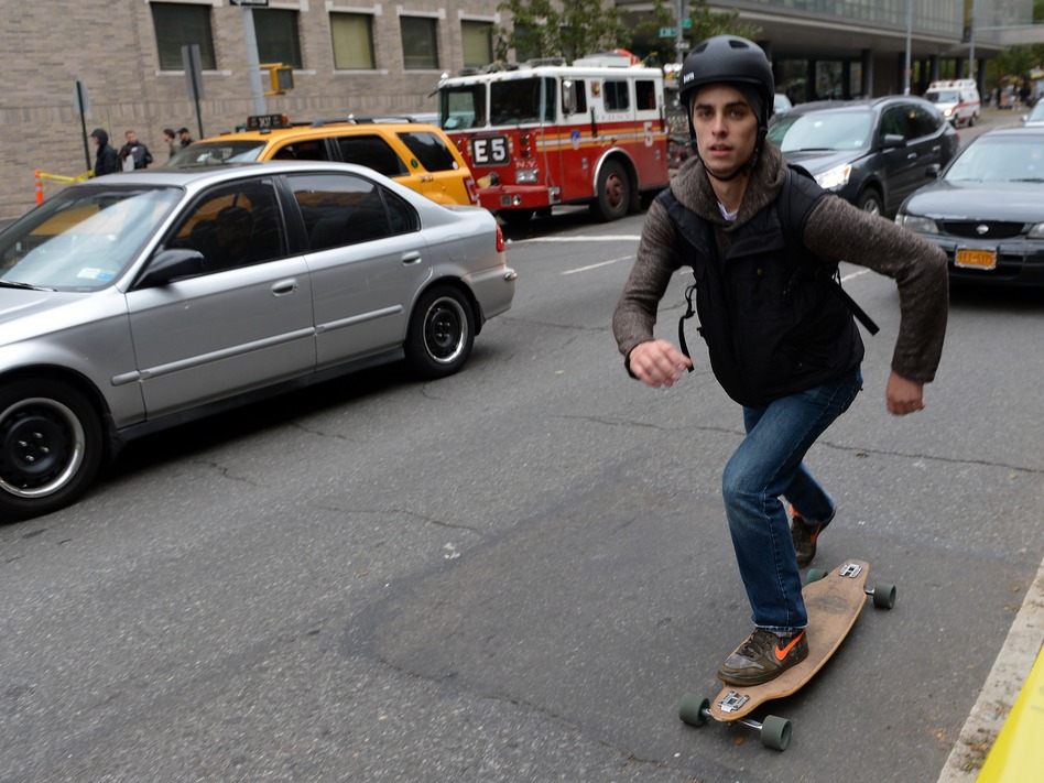 That's one way to get around: A skateboarder Wednesday on First Avenue in Manhattan. (Stan Honda /AFP/Getty Images)