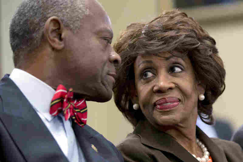 IN: California Democratic Rep. Maxine Waters smiles at her husband, Sidney Williams, during a House Ethics Committee hearing in September. Waters was cleared of charges that she steered a $12 million federal bailout to a bank where her husband owns stock.