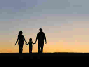 Silhouette of parents and child.