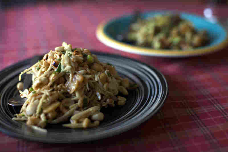 The menu features Indian curries and Thai noodles, but the restaurant's marquee items are fresh Burmese salads. In the foreground is a ginger salad.