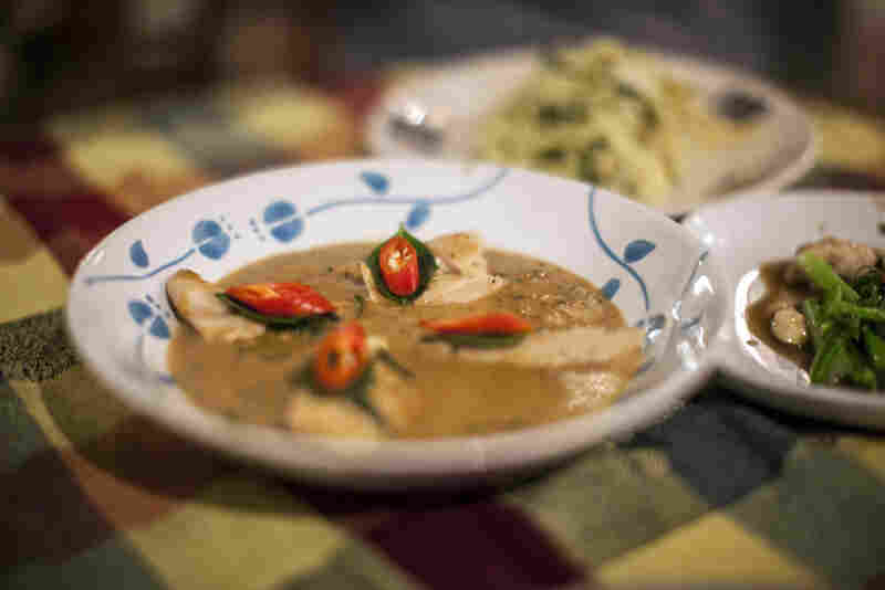 Myat Thu's wife created the Thai dishes on the menu. Thu says chicken panang curry is his wife's best dish. Chili peppers and Thai basil serve as flavorful garnishes.