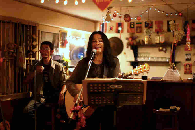 The restaurant features live music on Friday and Saturday nights. Myat Thu plays percussion during the band's rendition of Bob Dylan's "Blowin' in the Wind."