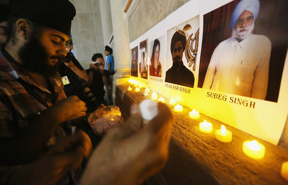 Photos of victims are seen during a candlelight vigil in Union Square for victims of the Wisconsin Sikh temple shooting on August. (Mario Tama/Getty Images)