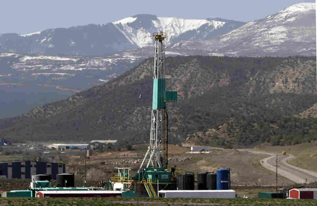 FILE - In this April 22, 2008 file photo, a natural gas well pad sits in front of the Roan Plateau near Rifle, Co. The director of the Colorado Oil and Gas Conservation Commission, David Neslin, said Monday, Dec. 5, 2011, that requiring drilling companies to publicly disclose what chemicals they use in hydraulic fracturing is only one tool for protecting public health and the environment.