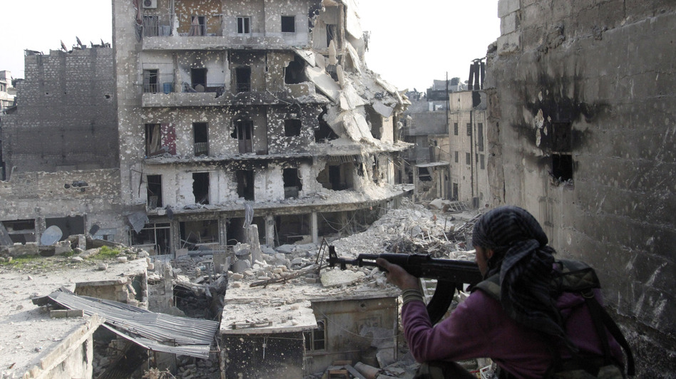 The Syrian military fired Scud missiles on rebel positions in northern Syria this week, a Pentagon source says. Here, a rebel fighter takes a position last month in the northern city of Aleppo, the scene of heavy fighting in recent months. (Anonymous/AP)