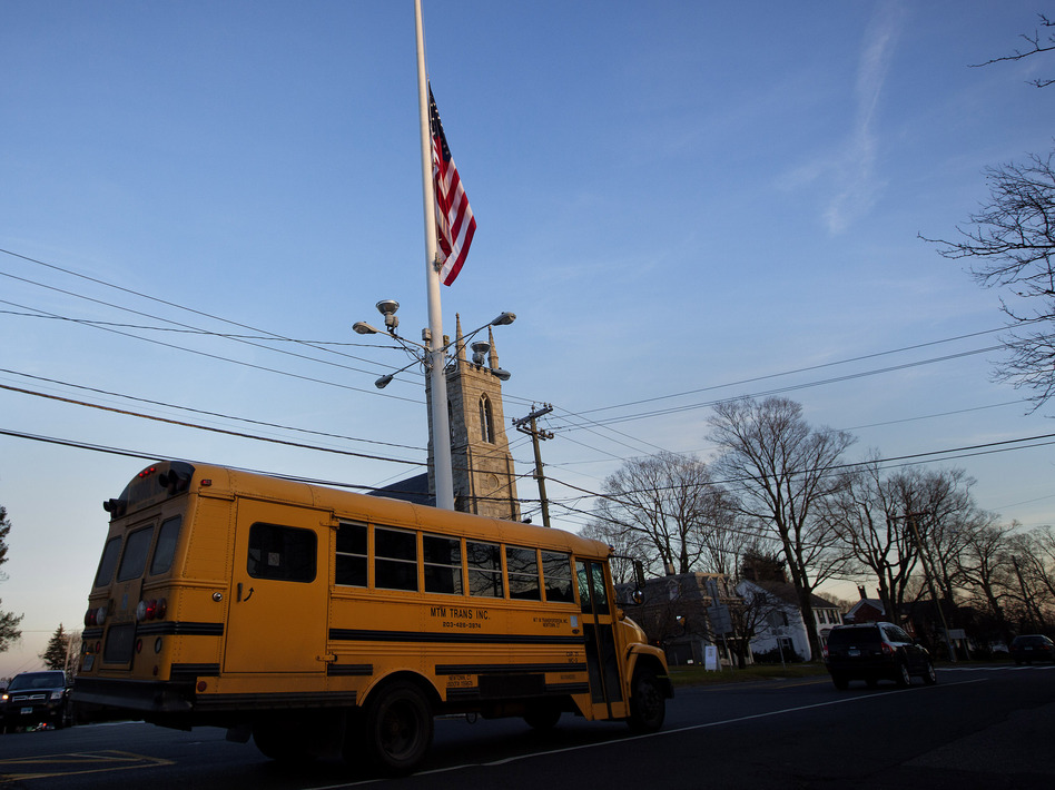 Friday afternoon: As a bus took some students home in Newtown, Conn., the flag was already at half-staff to honor the first-graders and school staff killed that morning. (Shannon Stapleton /Reuters /Landov)