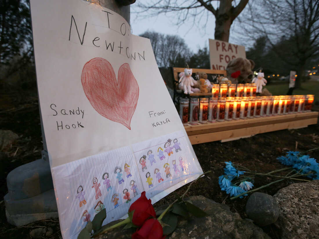 A sign stands at a makeshift memorial in Newtown, Conn., on Dec. 16.