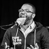Host Ophira Eisenberg interviews Baratunde Thurston on stage at The Bell House during a taping of Ask Me Another.