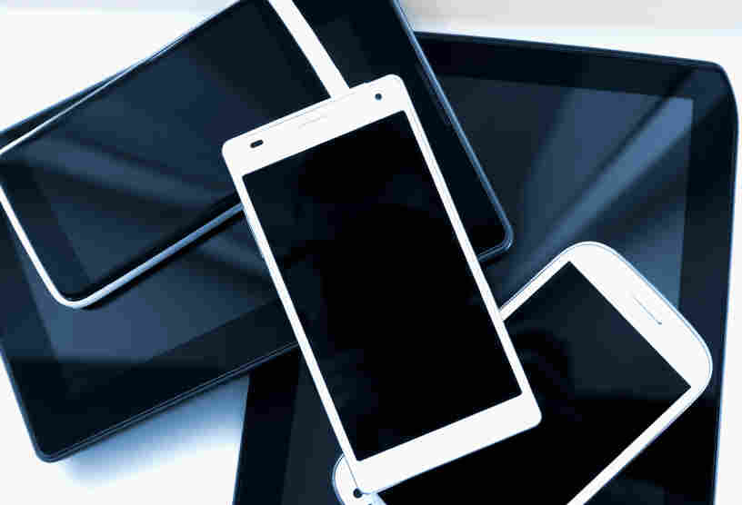 A pile of mobile phones and digital tablets.
