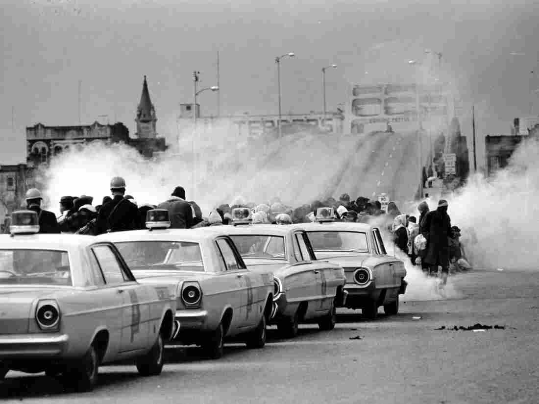 Tear gas fills the air as state troopers, ordered by Alabama Gov. George Wallace, to break up a march at the Edmund Pettus Bridge in Selma, Ala., on March 7, 1965, what became known as Bloody Sunday.