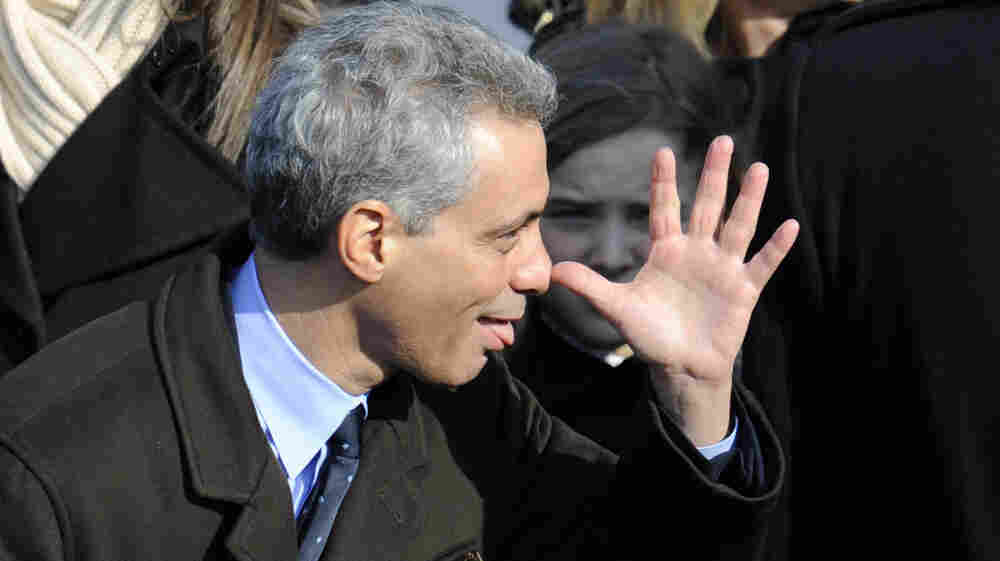 Incoming White House Chief of Staff Rahm Emanuel makes a face before President Barack Obama's inauguration in 2009. The person behind him does not look amused.