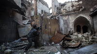 A rebel fighter fires toward Syrian government forces in the Bab al-Nasr district of Aleppo's Old City, earlier this month. The city has been a major battleground for the past six months.