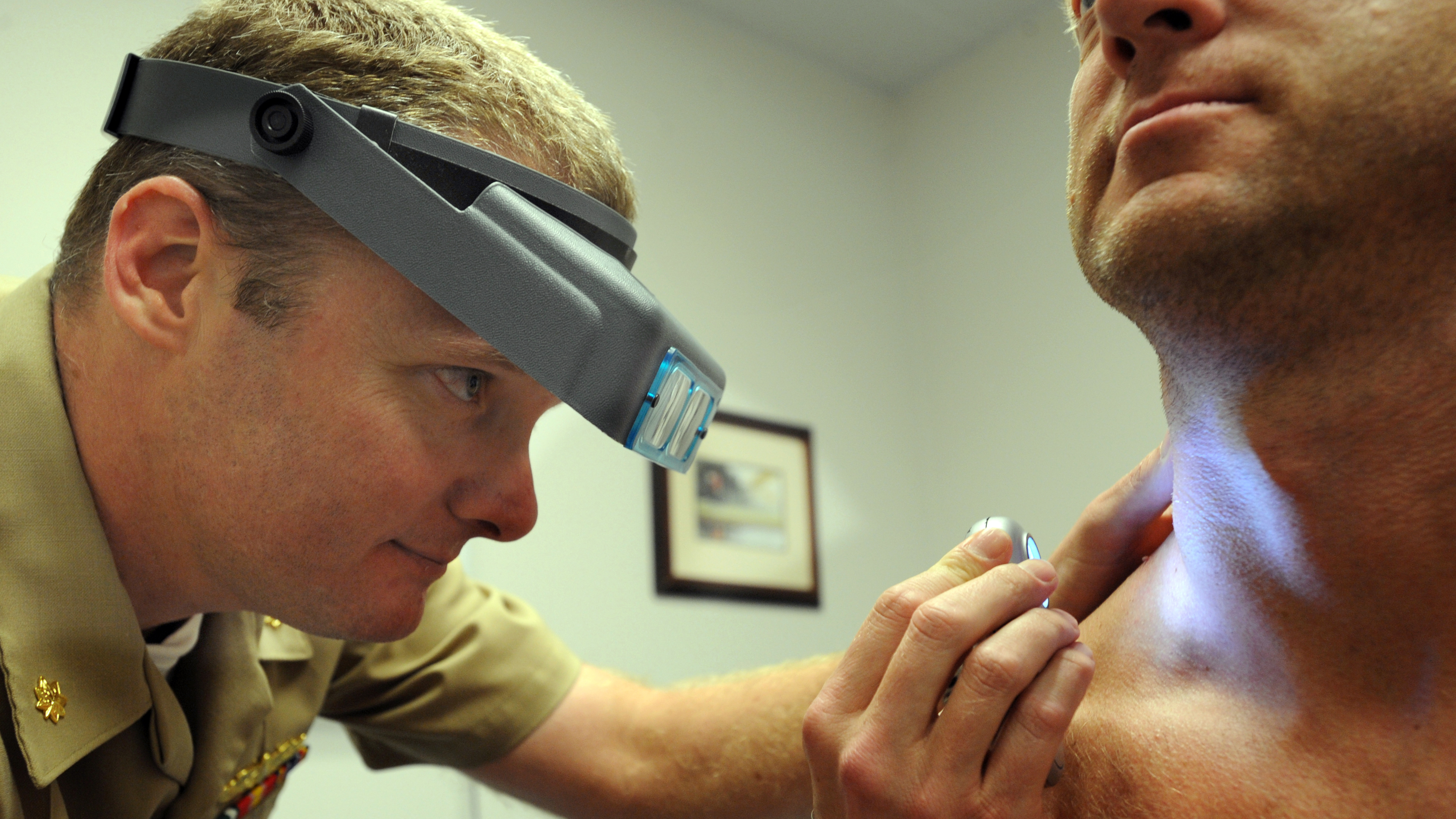 Lt. Cmdr. Stephen Mannino checks a sailor for skin cancer the old-fashioned way during a screening exam at  Naval Amphibious Base Coronado in San Diego. (U.S. Navy)