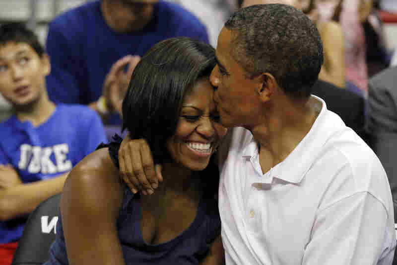 Aww: Obama sneaks an extra smooch after kissing Michelle for the "Kiss Cam" at the basketball game between U.S. and Brazil, on July 16, 2012, in Washington, D.C.