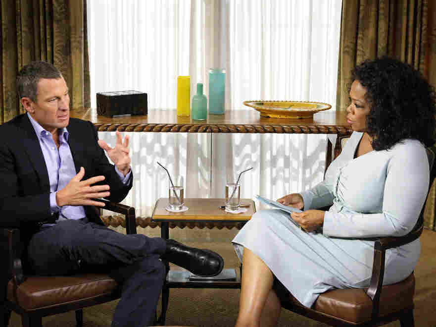 Oprah Winfrey speaks with Lance Armstrong during an interview.