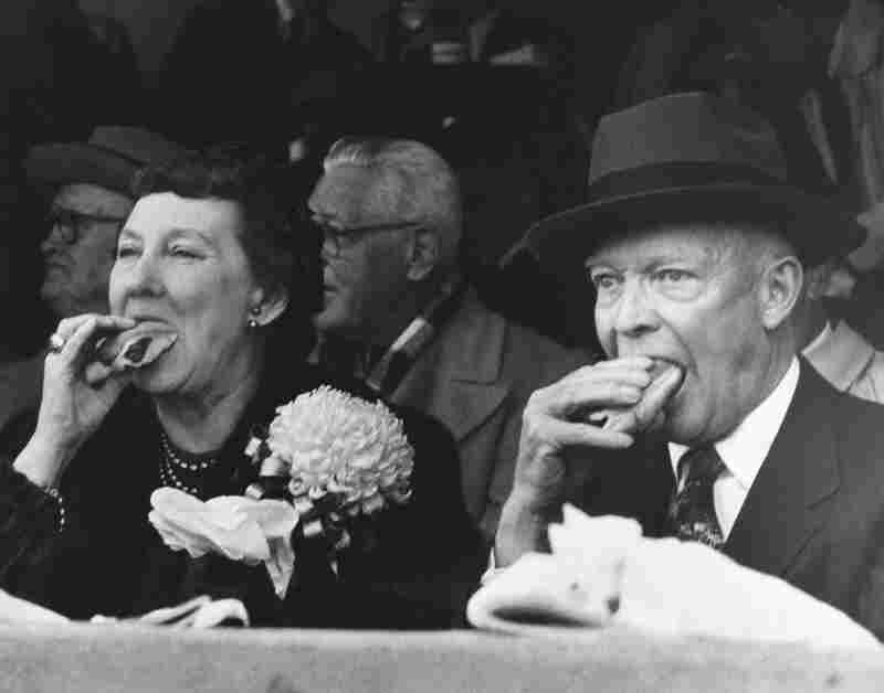 President Dwight D. Eisenhower and first lady Mamie Eisenhower eat hot dogs while watching the Army-Colgate football game in West Point, N.Y., in 1957.
