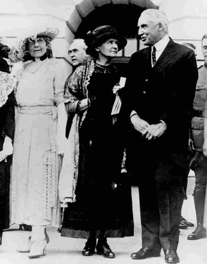 President Warren G. Harding speaks with Marie Curie at the White House. Before posing for photos outside, there was a ceremony in the East Room, but there wasn't enough light for the photographers.