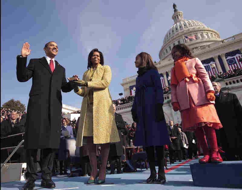President Barack Obama takes the oath at his 2009 inauguration, with first lady Michelle Obama and their daughters, Malia and Sasha, by his side.