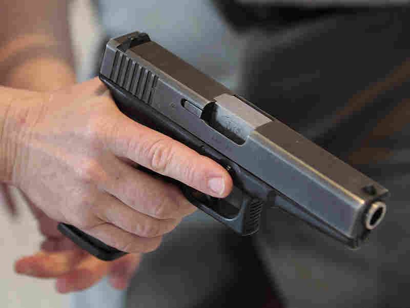 A Utah teacher is shown how to handle a handgun by instructor Clint Simon at a concealed-weapons training class Dec. 27 in West Valley City, Utah.