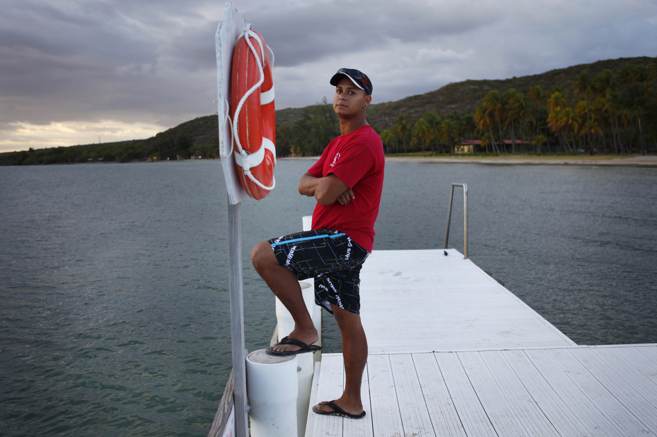 Edward Bonet, 23, lives in Cabo Rojo, Puerto Rico, and works on the dive team at the Copamarina Beach Resort & Spa in the town of Guanica. He lives with his grandmother, while his mother and sister live in Central Florida. (Coburn Dukehart/NPR)