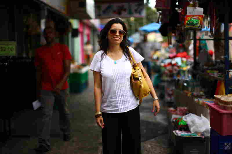 Rosario Rivera is an economist and professor at the University of Puerto Rico. She lives on the island with her husband, a lawyer, but they've considered moving to the mainland. She is seen here at a street market in the Rio Piedras neighborhood of San Juan.