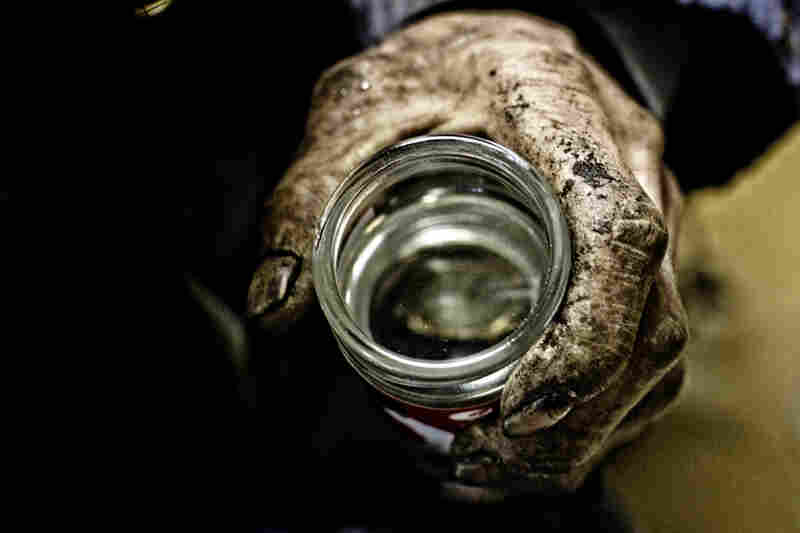 Yasu, an unemployed day laborer, drinks $1 sake in Kamagasaki. It used to be called a "laborers town" but is now called a "welfare town" — a dumping ground of old men. Alcoholism, poverty, street death, suicide, TB and most of all loneliness prevail here.