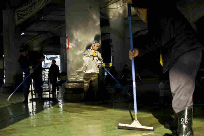 Men mop the floor of a labor center, which is sponsored by the government and provides the main source of income to a select few in Kamagasaki. People used to be able to get high-paying jobs in this town, but now there is no work, especially for the aging male population.