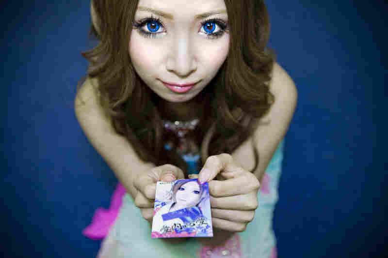 Shiho Fukada's four-part photo series documents the effects of Japan's changing economy on both the young and the old. Here, Cocoa, 21, shows off her business card for her job as a "hostess." Working as a hostess is a popular job for Japan's young women. But it comes with an expiration date — when they get too old, they are no longer wanted, leaving them with no skills and few options.