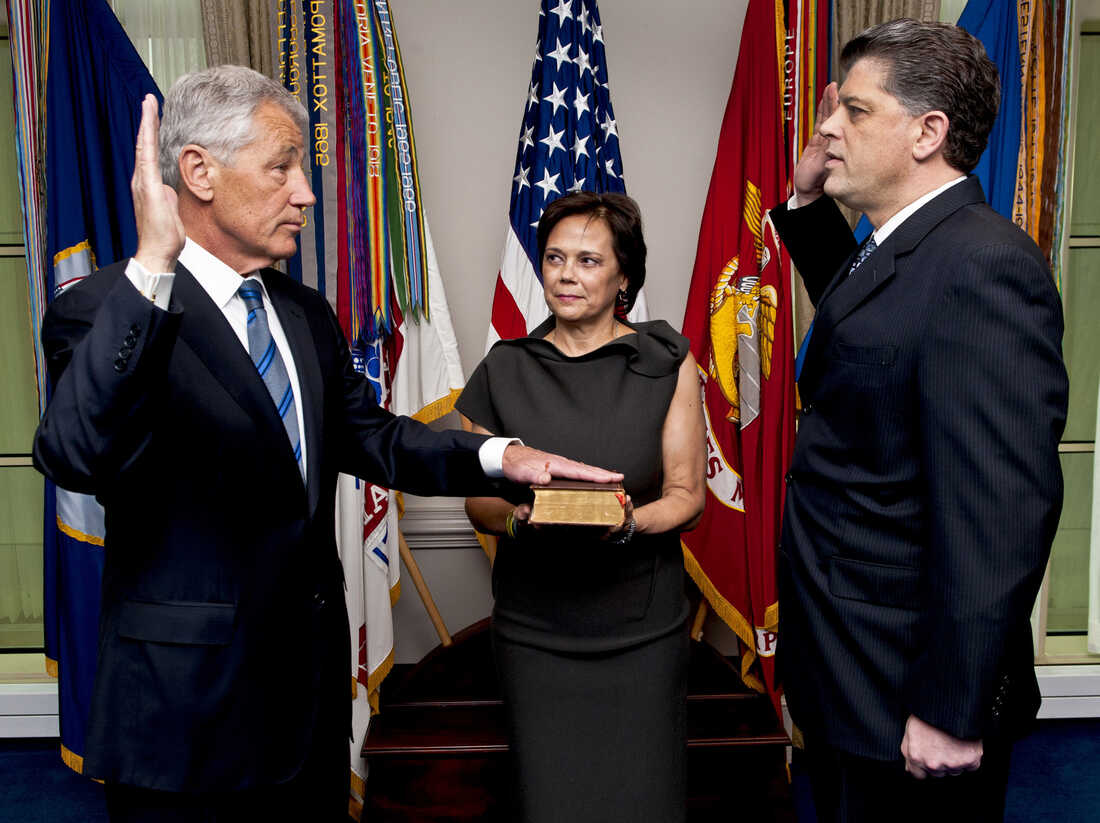 As his wife Lilibet holds the Bible, Chuck Hagel (L) is sworn into office on Feb. 27, 2013.