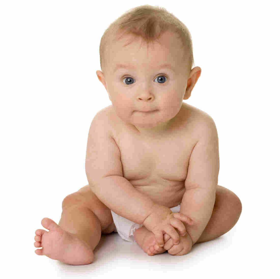 A baby sitting and looking at the camera