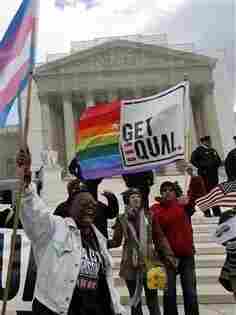 In this photo taken Wednesday, March 27, 2013, demonstrators holding flags chant in front of the Supreme Court in Washington. (AP Photo/. (AP Photo/Jose Luis Magana)
