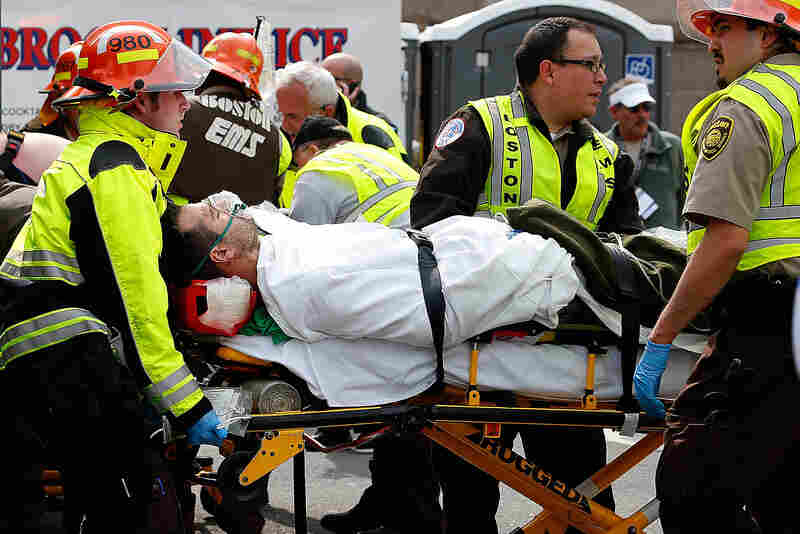 A man is loaded into an ambulance after he was injured by one of two bombs that exploded during the Boston Marathon on Monday. 
