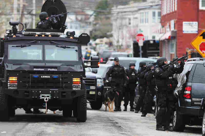SWAT team members search for the remaining Boston Marathon bombing suspect at an apartment building. One of the two suspects died after a chase and shootout earlier Friday. The second was captured late Friday night.