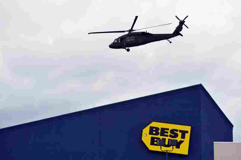 A National Guard helicopter takes off in Watertown, Mass., after landing in a shopping mall as part of search operations for one of the bombing suspects.