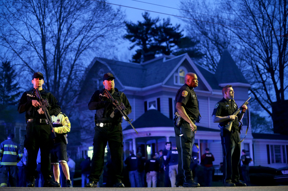 Police officers guard the entrance to Franklin Street in Watertown, Mass., where Boston Police say they have captured the second suspect in the marathon bombings. (Matt Rourke/AP)