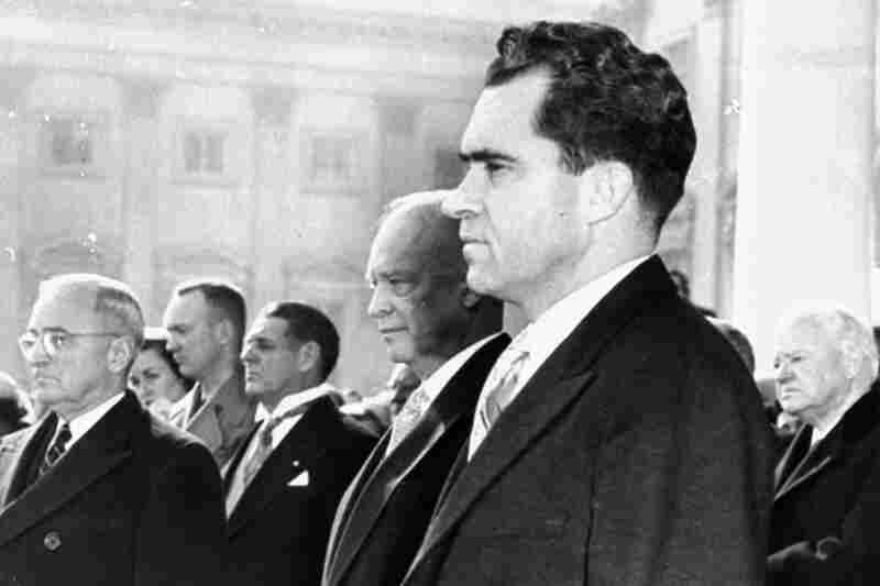 Vice President Nixon, foreground, President Eisenhower, immediately behind, former President Truman, left, and former President Hoover, right, stand on the inauguration stand in front of the Capitol, January 20, 1953, during the singing of "The Star Spangled Banner" at Eisenhower's swearing-in ceremony.