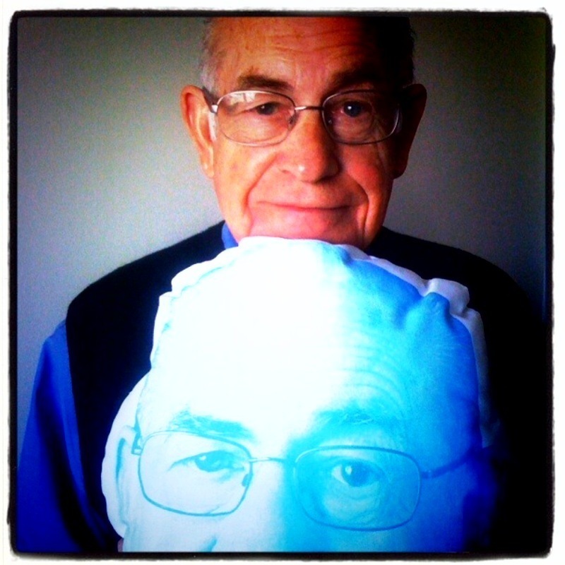 Carl Kasell squeezes a pillow designed after the legendary broadcaster himself. Snag your own at the NPR Shop.