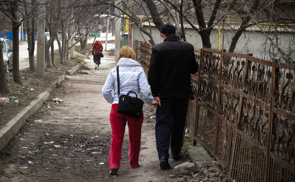 Oxana and Pavel Rucsineanu walk to the tuberculosis hospital in Balti, Moldova. Oxana and their new baby live in an apartment, but Pavel still has to stay at the TB ward, fighting for his life. (NPR)