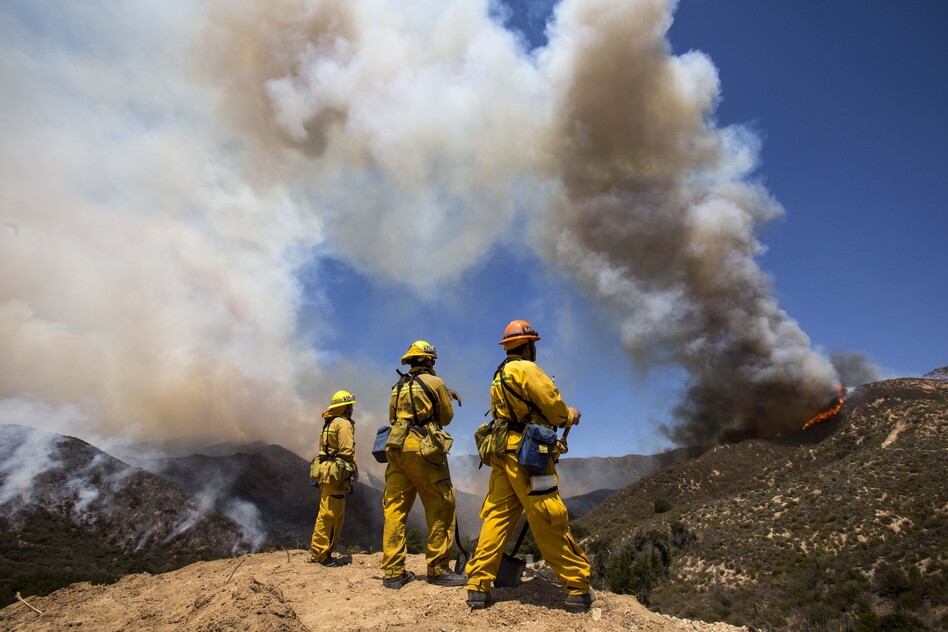 Firefighters keep watch at Green Valley as the fire has burned more than 1,400 acres since Thursday in the Angeles National Forest just north of Castaic, in California.