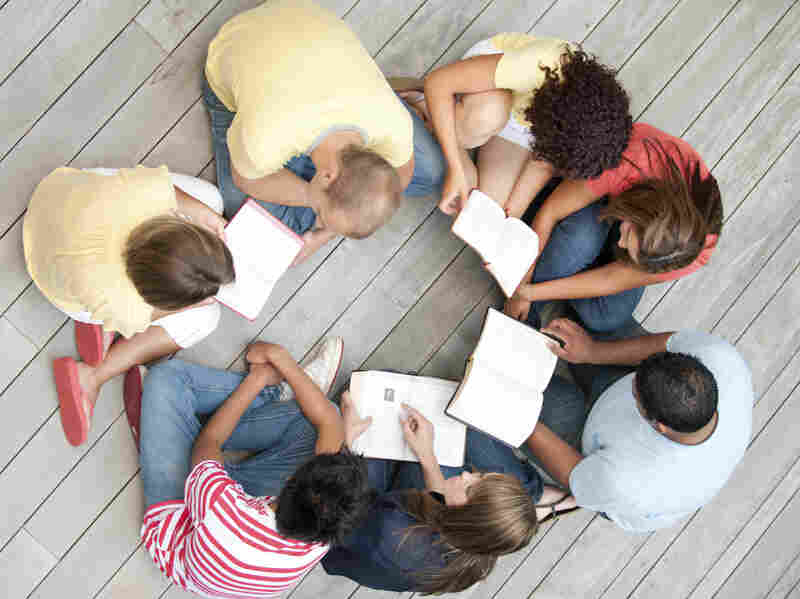 A group of young adults reading