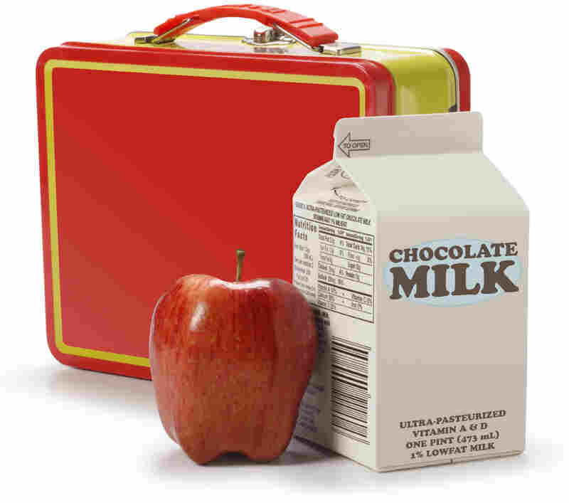 A milk carton, apple and lunchbox.