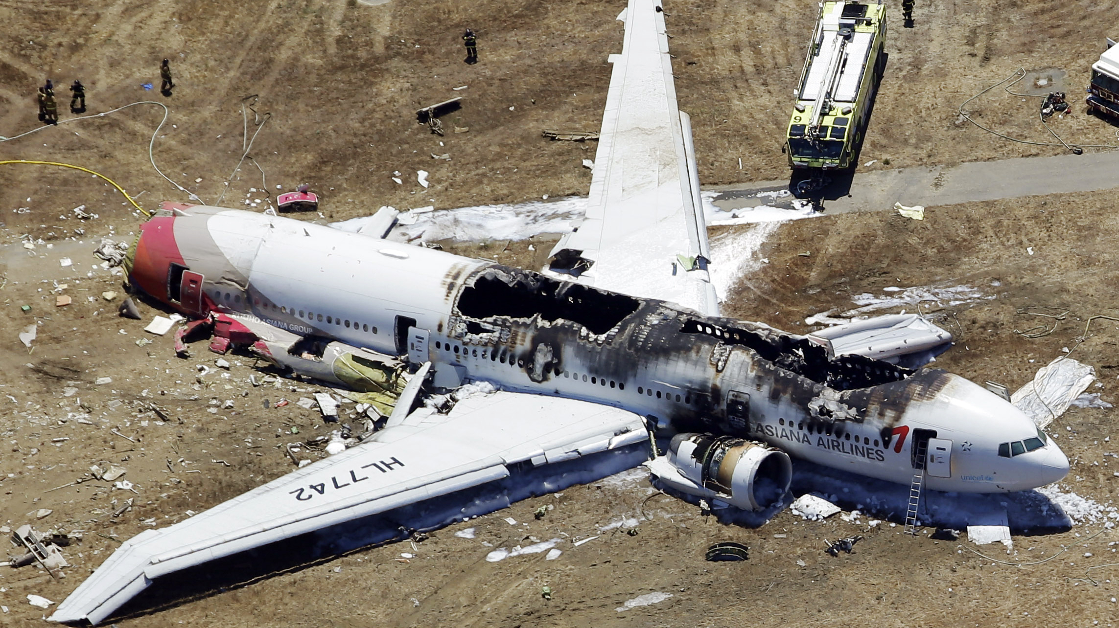 The wreckage of Asiana Flight 214, a Boeing 777 airliner, is seen after it crashed at the San Francisco International Airport Saturday. The crash-landing killed two teenage Chinese girls, the airline says. (AP)