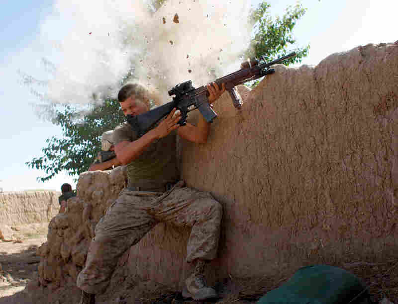 Sgt. William Olas Bee, a U.S. Marine from the 24th Marine Expeditionary Unit, has a close call as Taliban fighters open fire near Garmsir in Helmand province, Afghanistan, 2008.