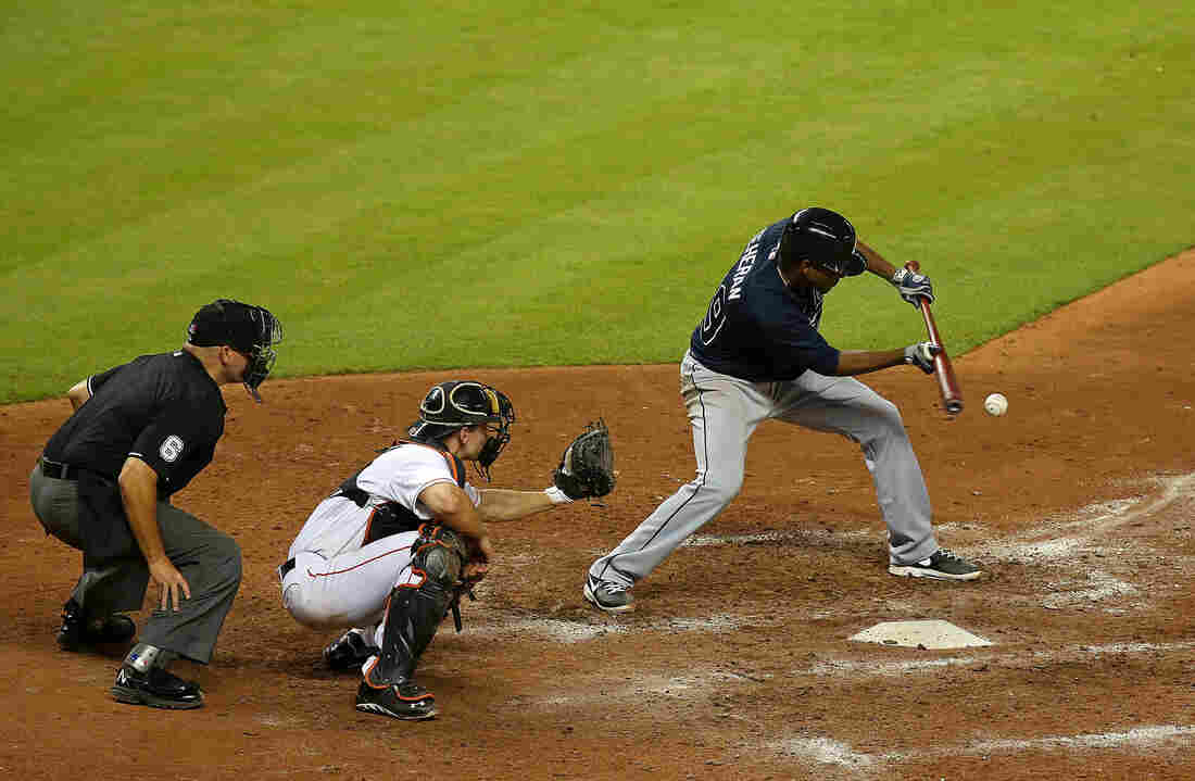 Julio Teheran of the Atlanta Braves bunts during a game against the Miami Marlins at Marlins Park on July 9, 2013 in Miami, Florida.