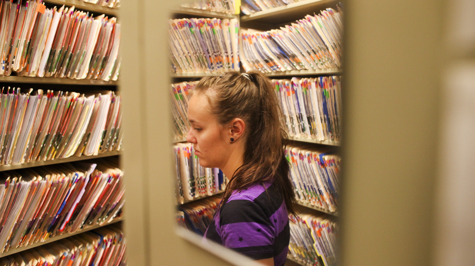 Heather Garris, a custodian of medical records, organizes patients' files at Colorado Springs Internal Medicine in Colorado Springs, Colo. (Barry Gutierrez for NPR)
