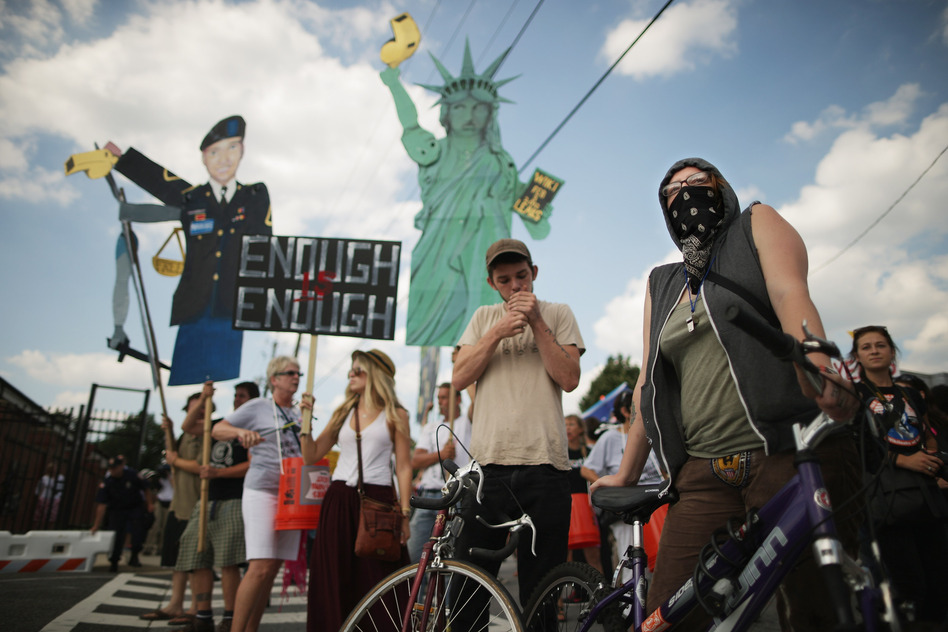 Supporters of U.S. Army Pfc. Bradley Manning protest his detention by marching around the perimeter and blocking the gates of Fort McNair in Washington, D.C., on the final day of closing arguments in his military trial Friday. (Chip Somodevilla/Getty Images)