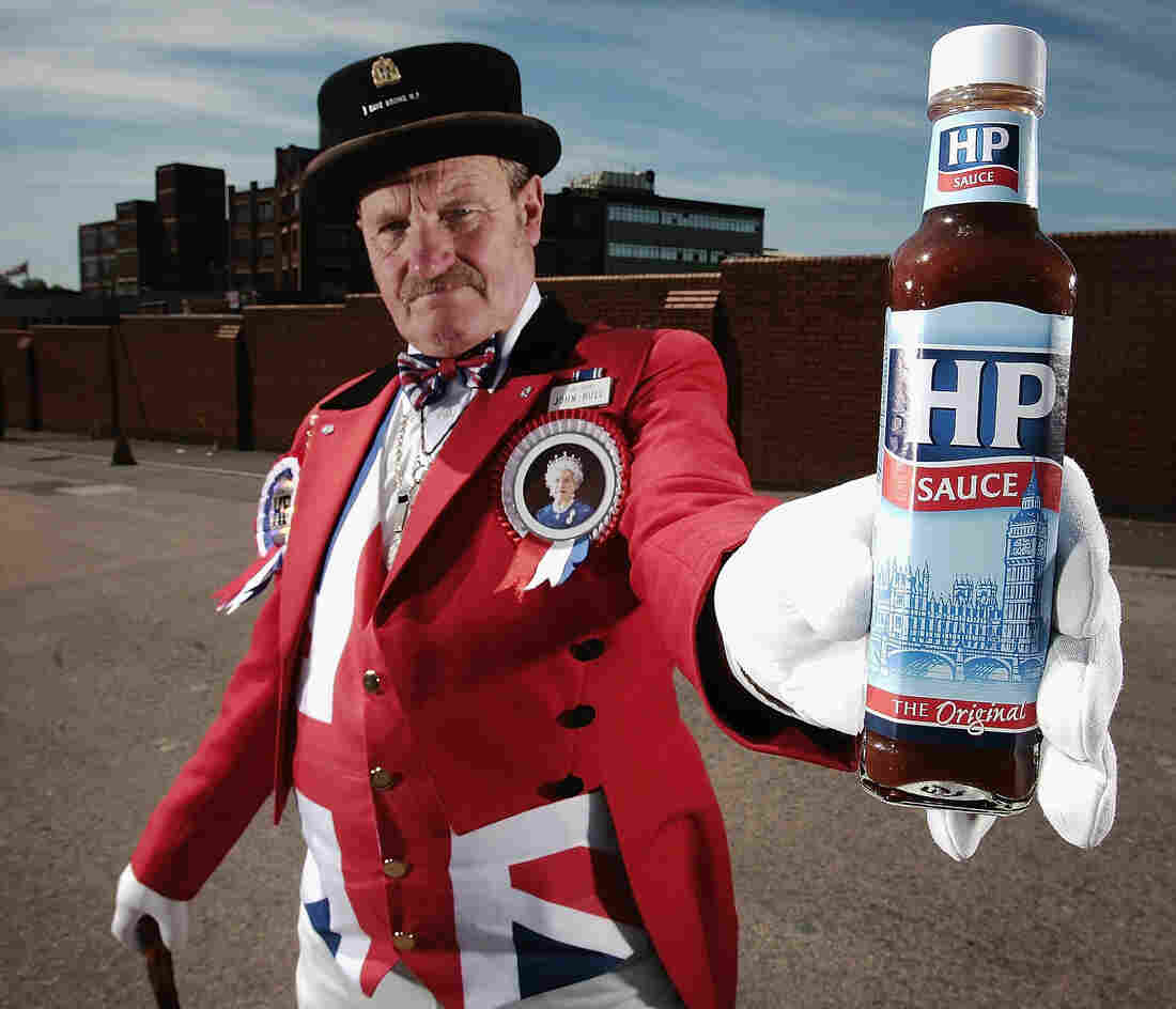 John Bull alias Ray Egan poses with a bottle of HP sauce as workers from Birmingham's HP Sauce company protest outside the factory against closure on June 3, 2006, in Birmingham, England. The HP Foods factory in Birmingham is to close and production of its famous sauce moved to Holland. HP which stands for Houses of Parliament is an iconic British brand.