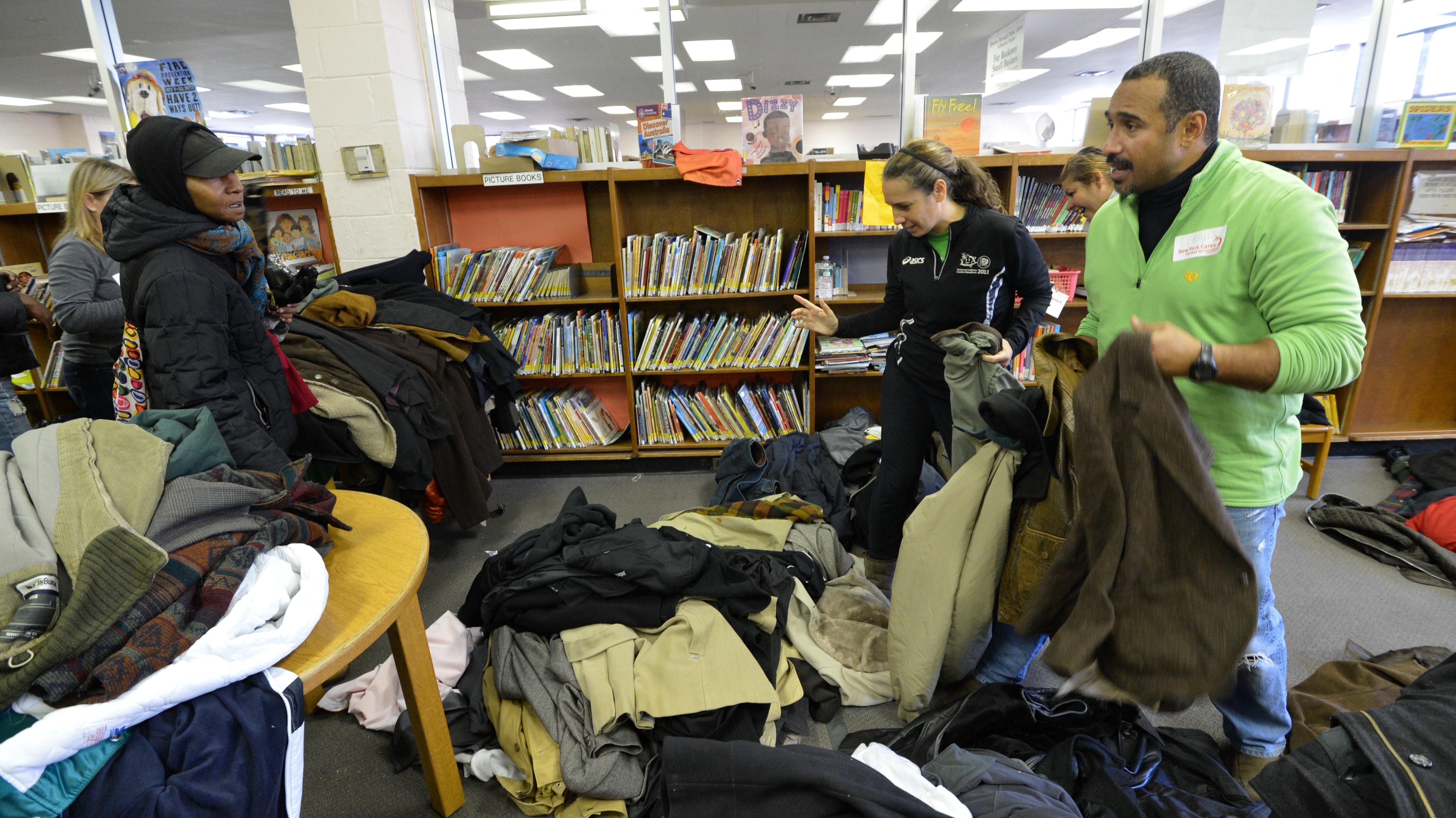 Volunteers at the Queens Library in the Far Rockaway section of Queens hand out coats to people affected by Hurricane Sandy. (AFP/Getty Images)