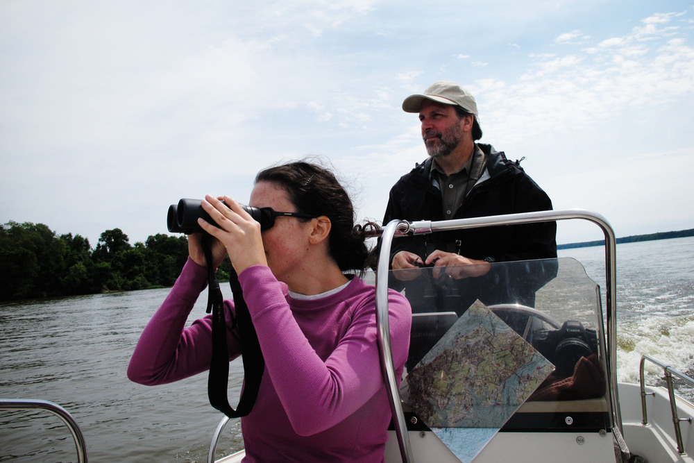 Bryan Watts, a conservation biologist at the College of William and Mary, and biology graduate student Courtney Turrin, survey eagle behavior along the James River in late-summer. (NPR)