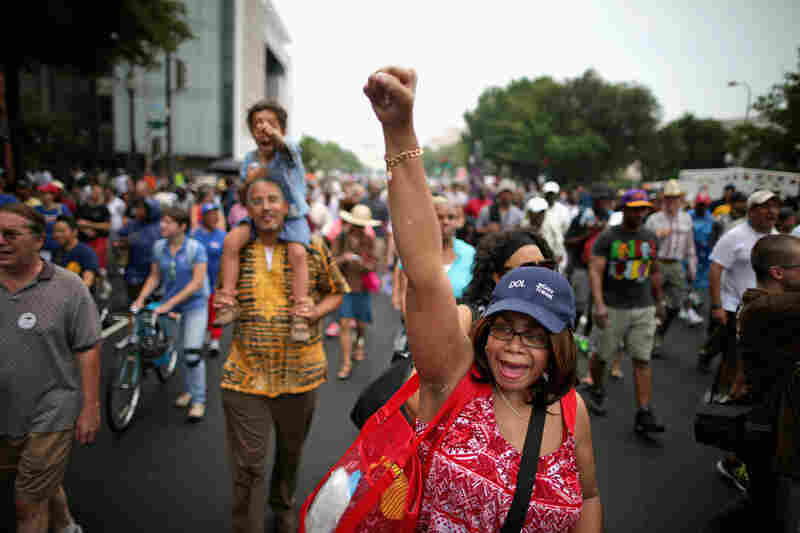 Thousands of people, including Joyce Elliotte, march from Capitol Hill to the Lincoln Memorial to commemorate the historic march for jobs and freedom.